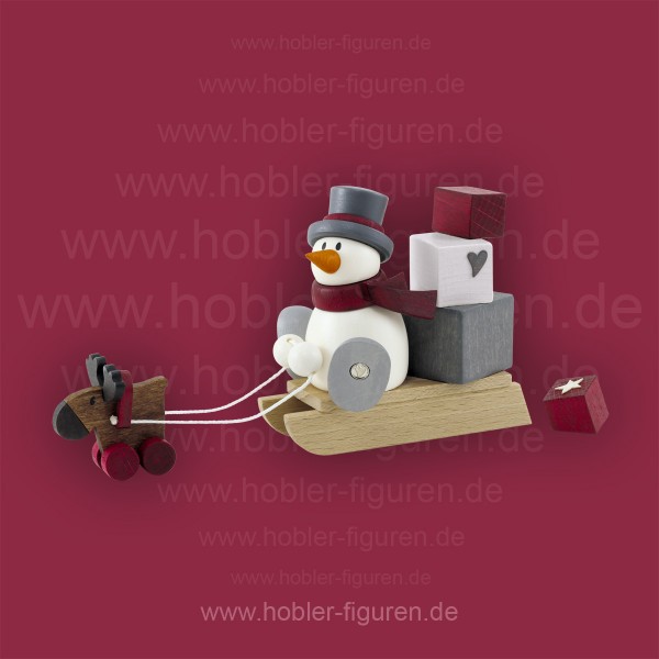 Schneemann Otto mit Geschenkeschlitten